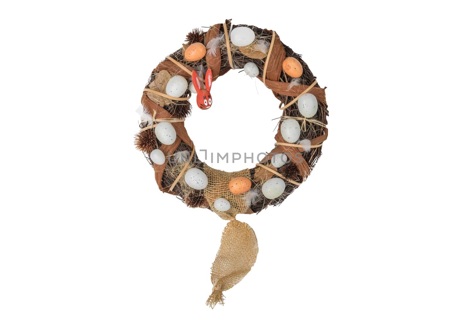 Easter willow wreath with eggs and wooden easter bunny isolated on white background. Happy easter.