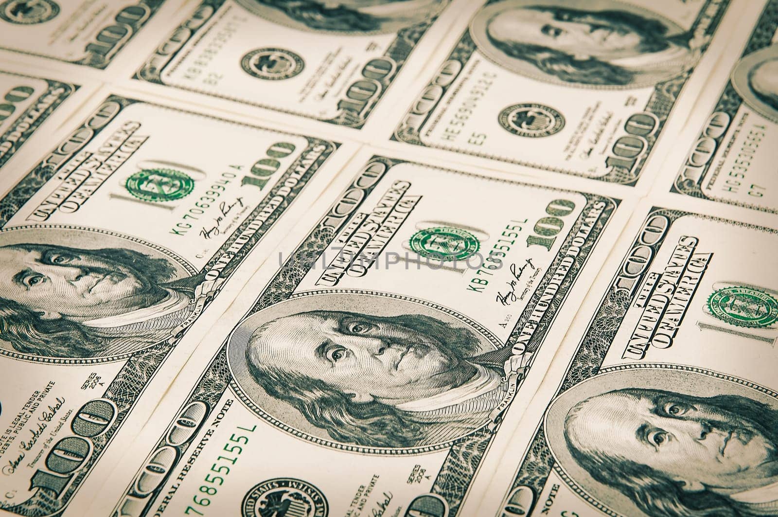 Denominations of one hundred dollars are arranged in a row. Processing under the antiquity. View at an angle. Isolated.