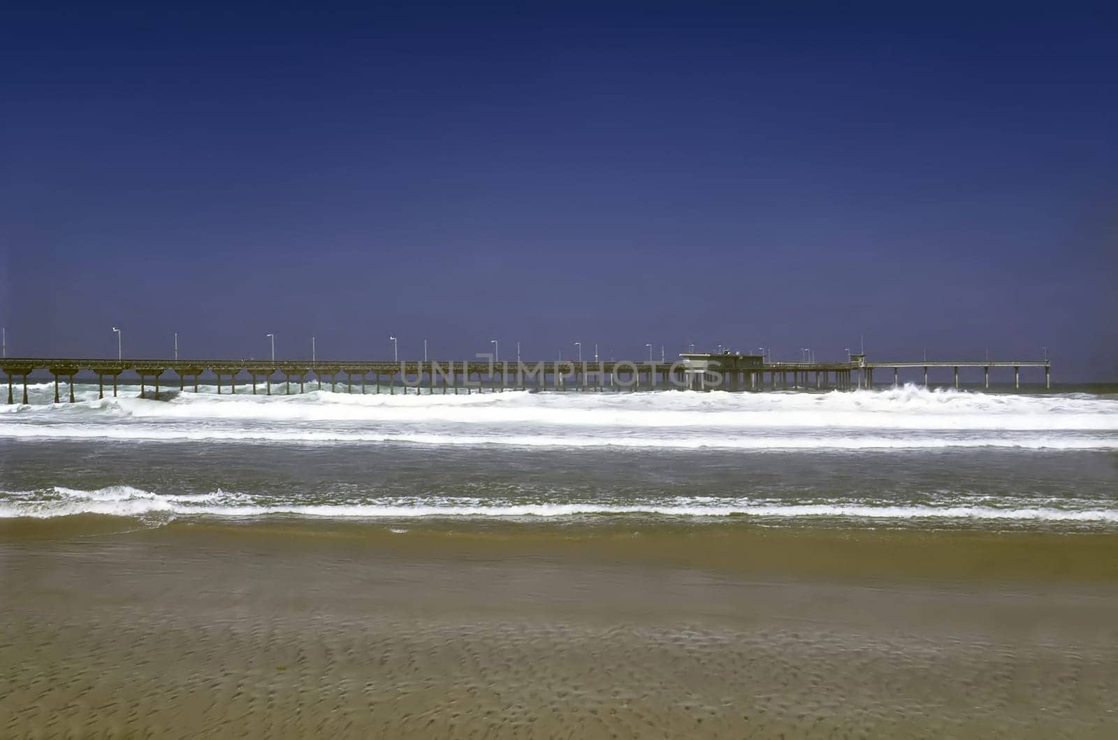 Pier on shore of Pacific Ocean in California
