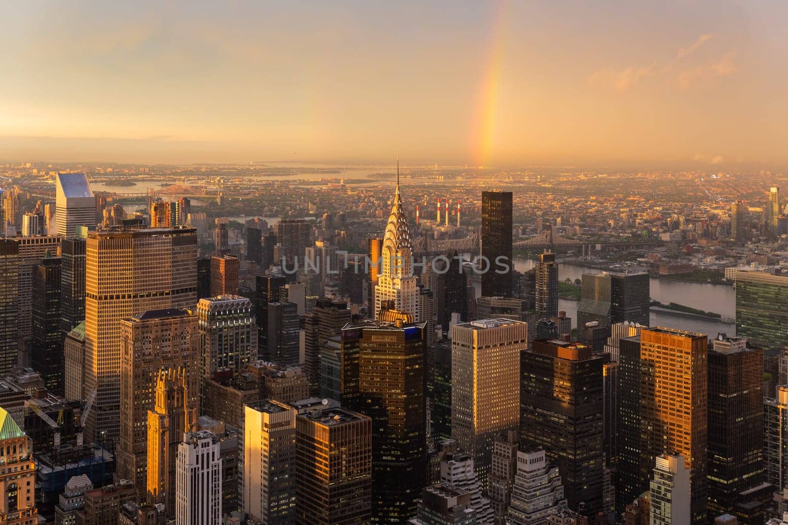Skyscrapers at midtown New York City with the East River on the background at dramatic after the storm sunset light, USA.