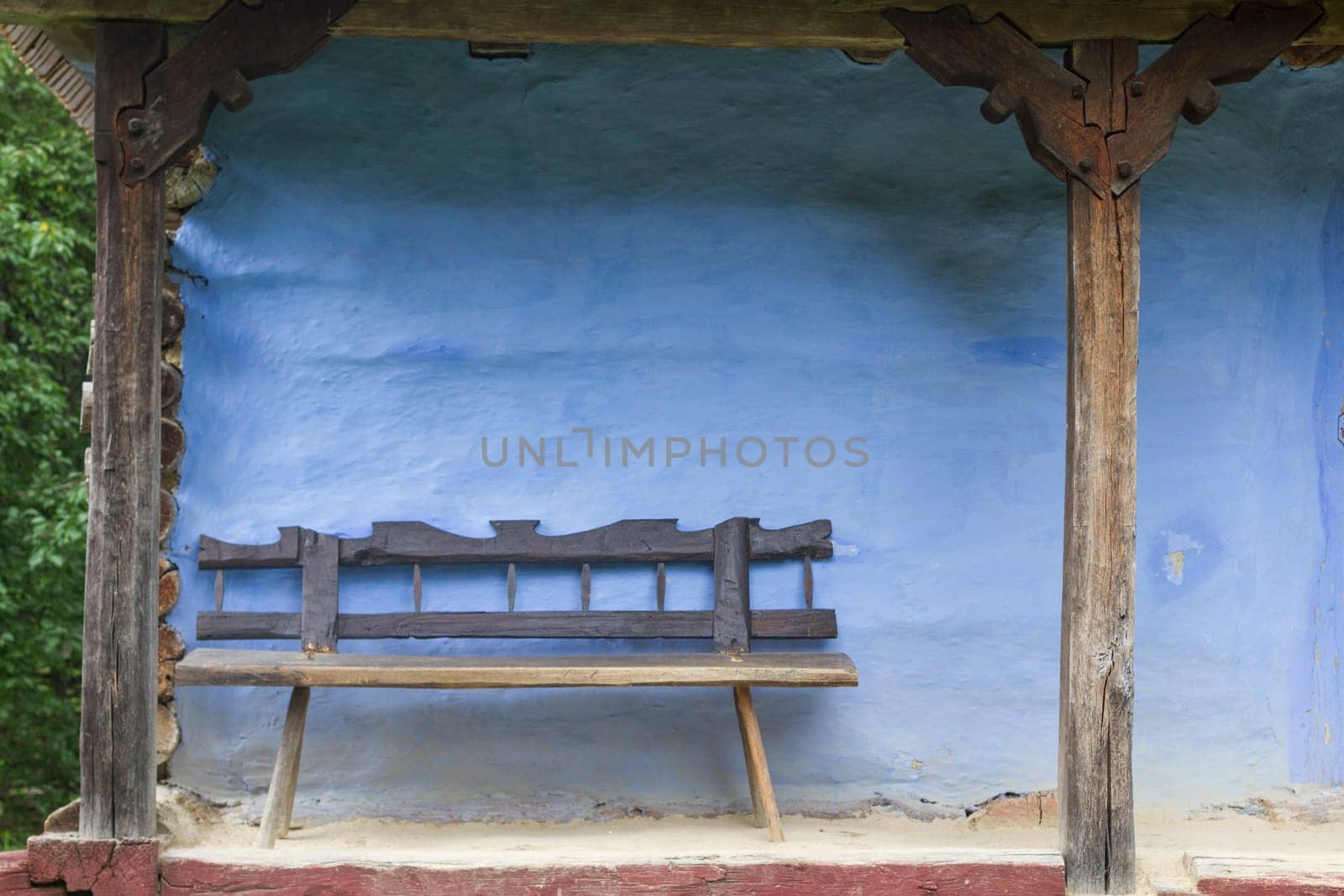 Old Wood Bench with Blue Log House