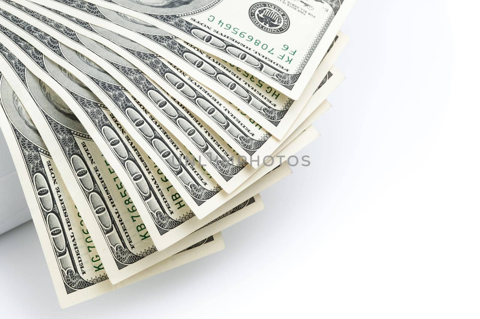 Parts of the bills of one hundred dollars are located on the left with a fan.