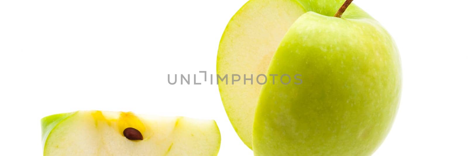 Slice is cut off from a large fresh green apple.