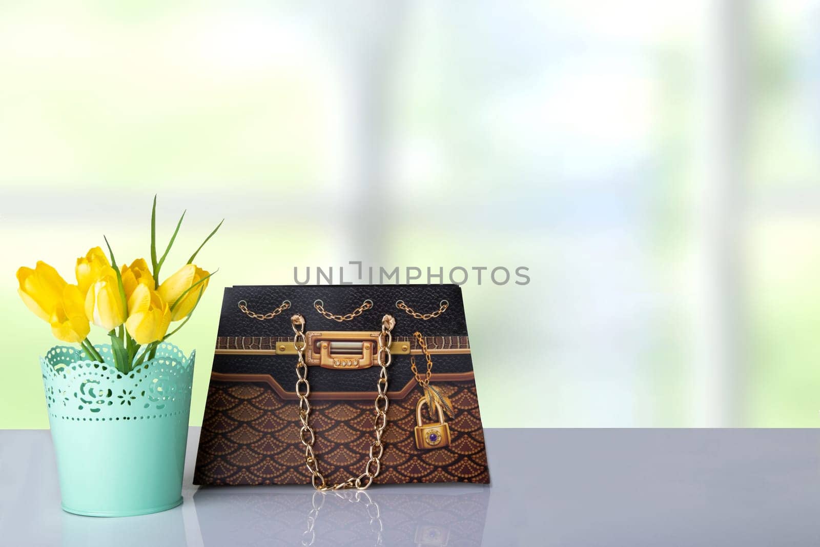 Bouquet yellow tulips and a brown gift paper bag on table in front of abstract colorful bright background. Space for your product display montage. Mother day, valentine or other holidays.
