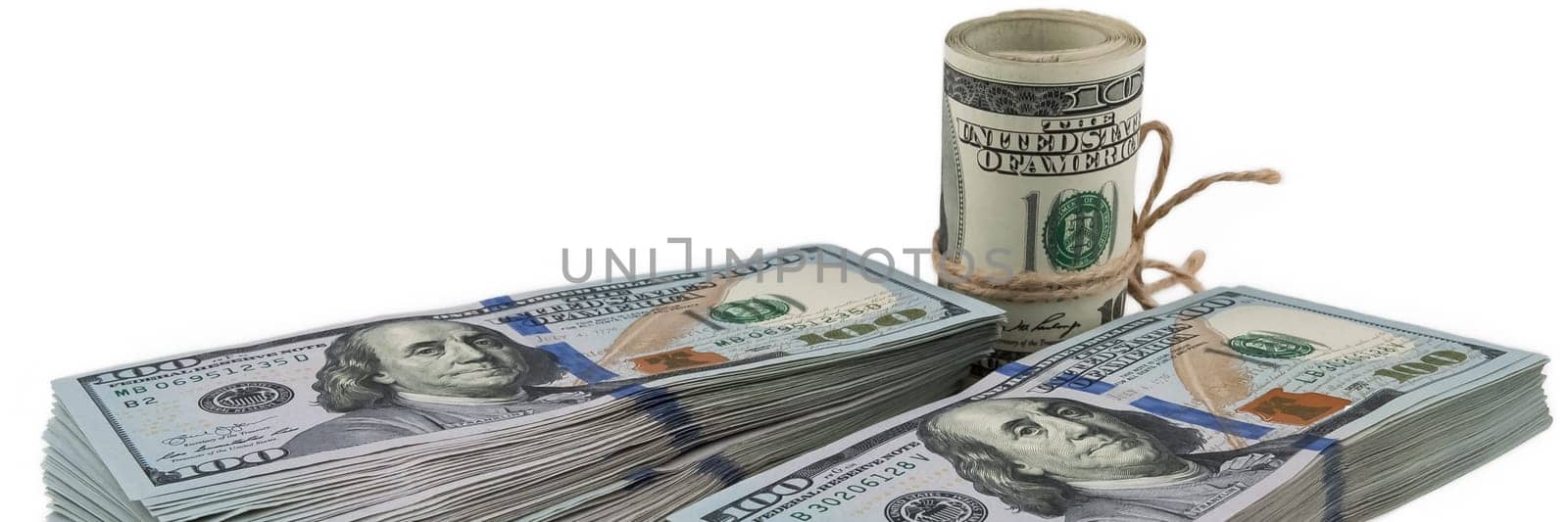 Two packs of one hundred dollar bills and a roll of dollars tied with a rope on a white background. View at an angle. Isolated.