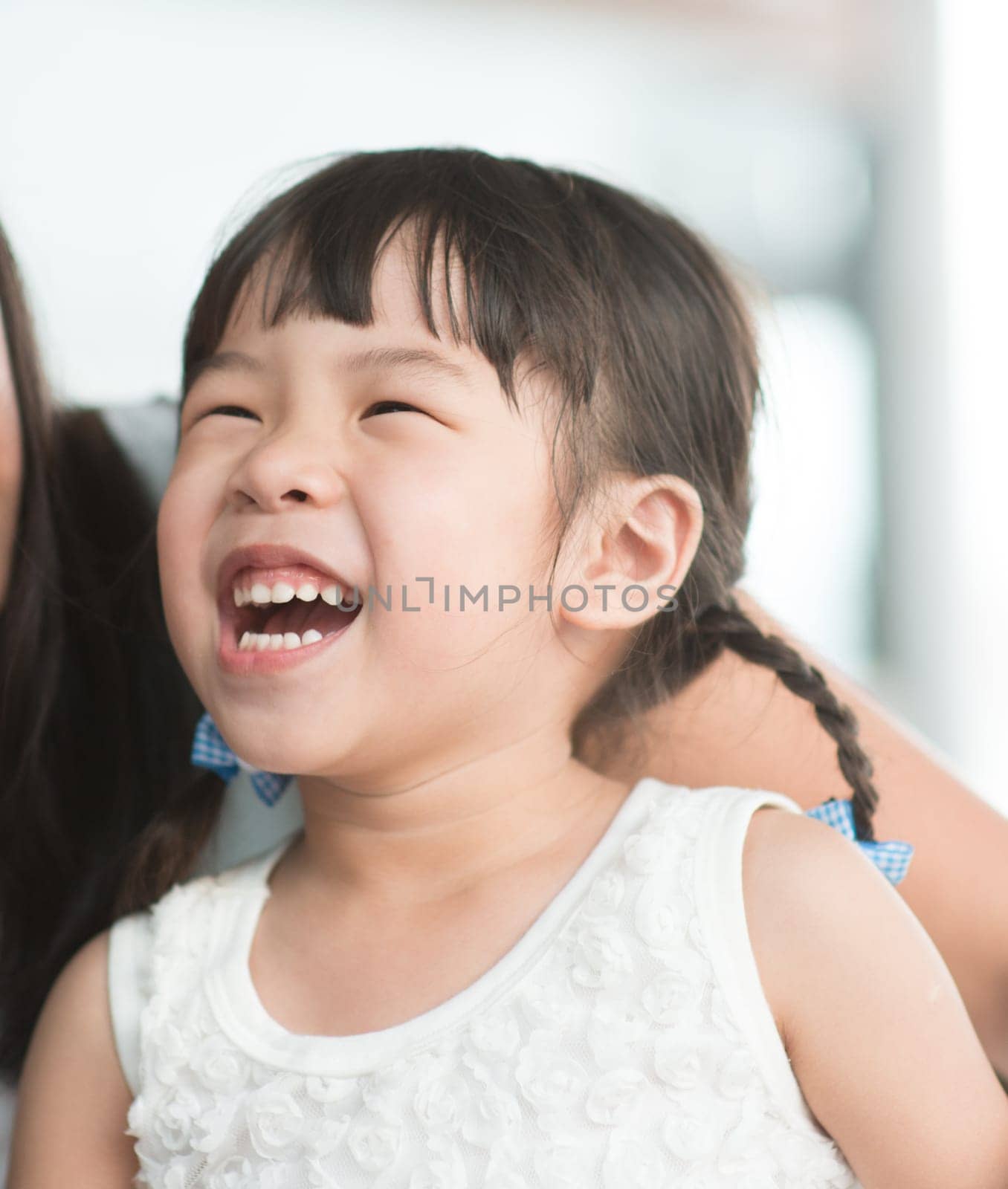 Candid shoot of people in cafeteria. Little girl with various face expression. Asian family outdoor lifestyle with natural light.