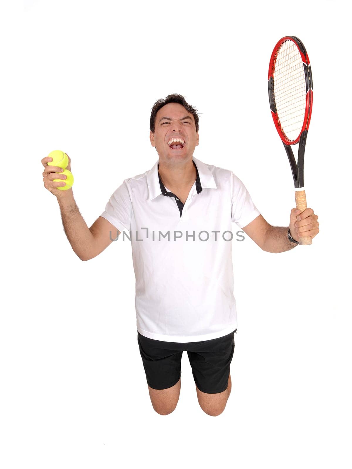 A very happy young man kneeling on the floor celebrating his victory.on his tennis game, isolated for white background.