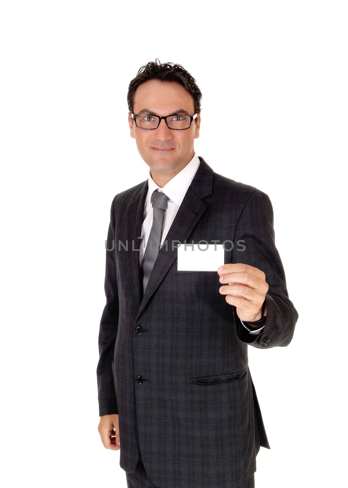 A handsome young business man standing in a suit and tie, holding up.his new business card, isolated for white background.