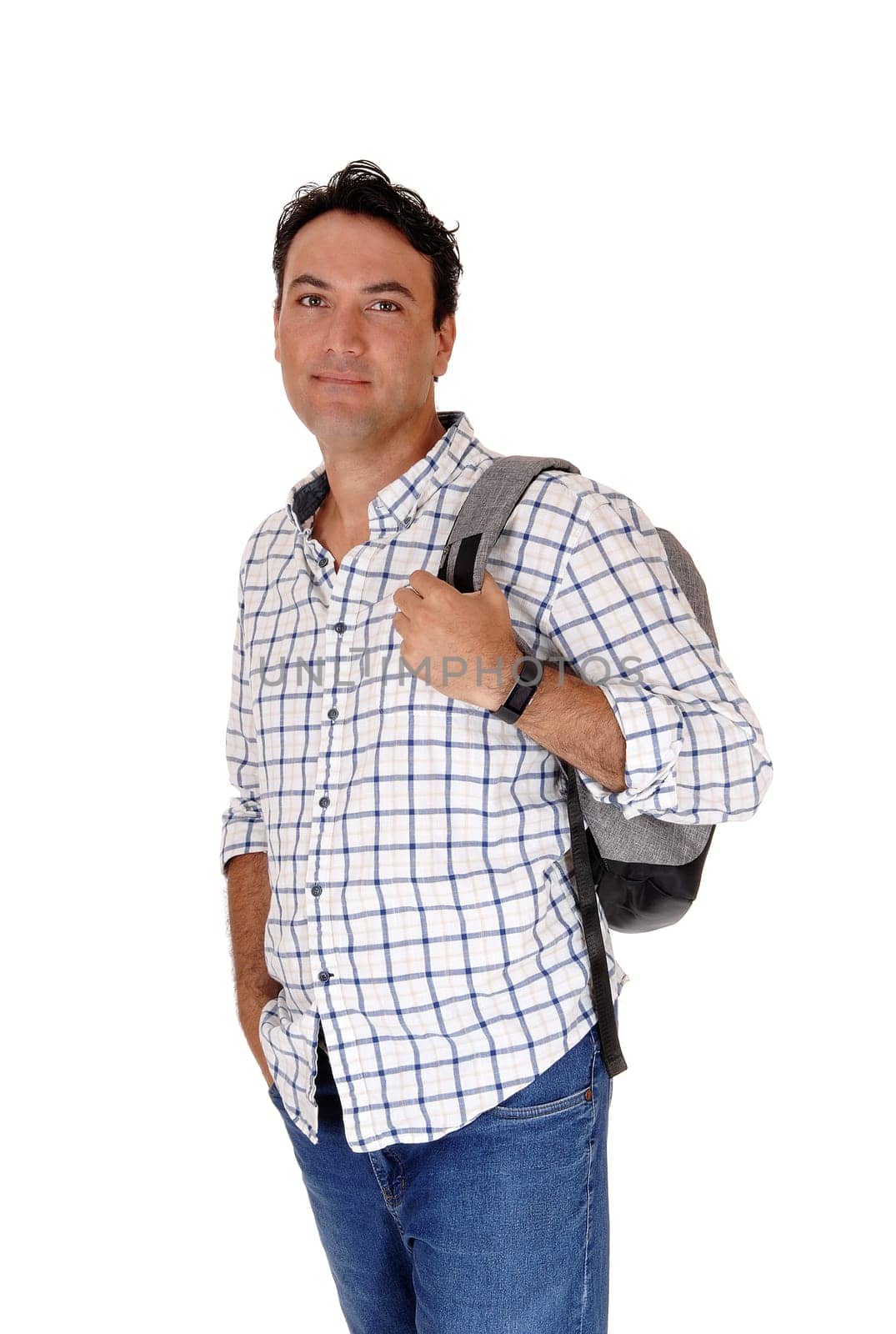 A handsome young man standing in profile looking into the camera.with his backpack on his back, isolated for white background.