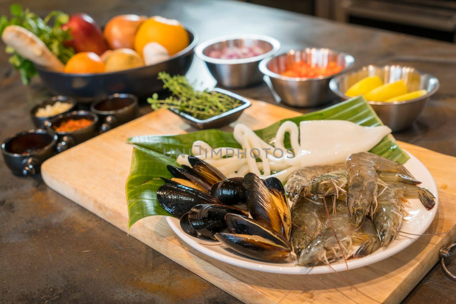 Raw seafood on plate with fruits and vegetables, healthy food, prawn, clam squid.