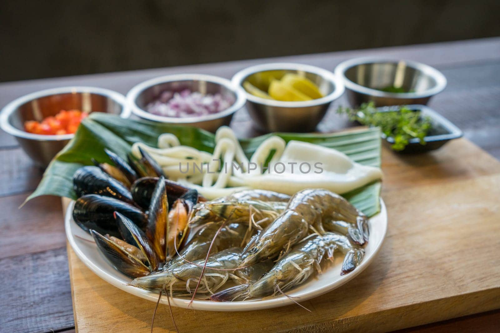 Raw seafood on plate, healthy food, prawn, clam squid.