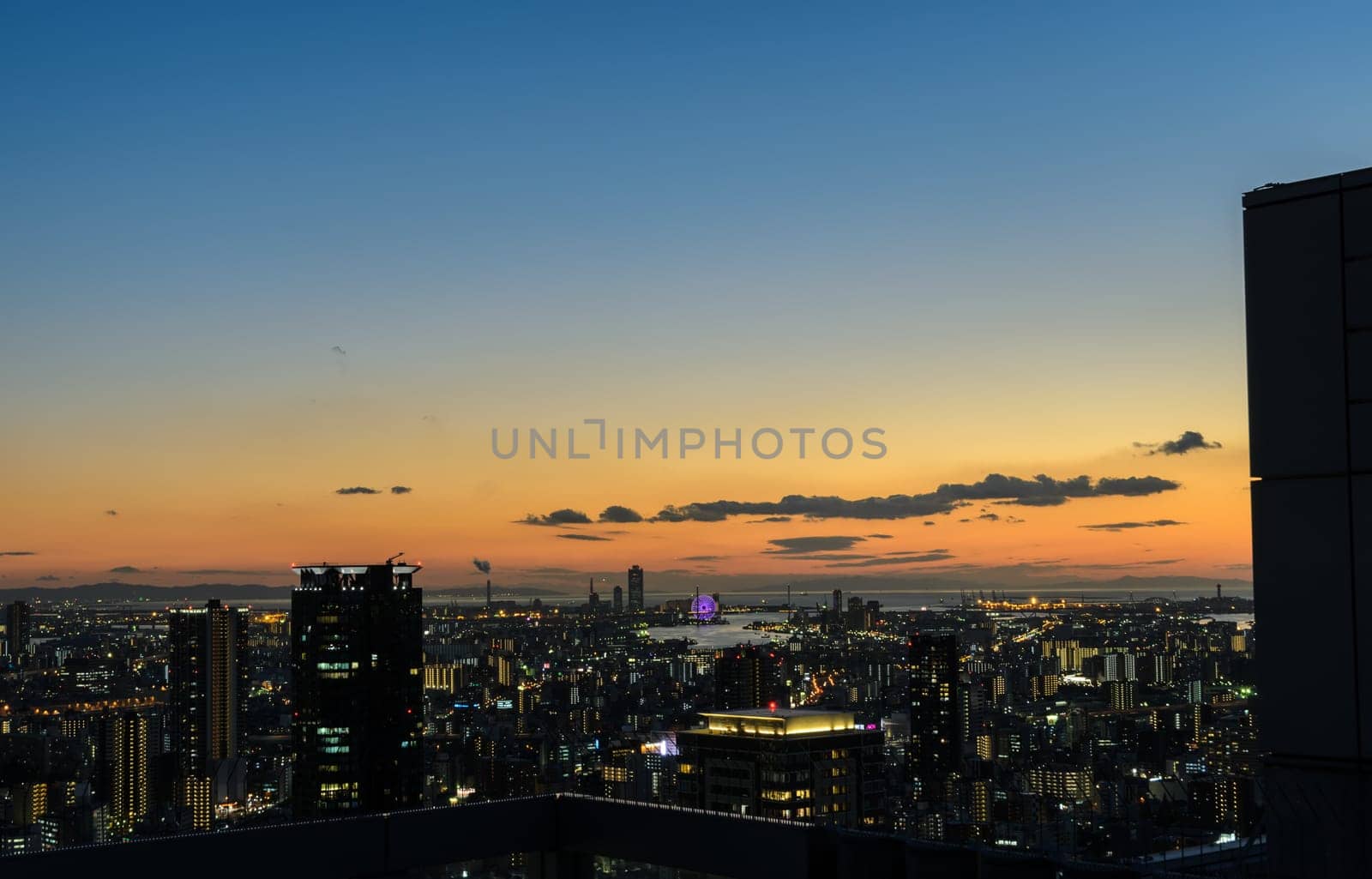 OSAKA, JAPAN - NOVEMBER 25, 2016 : Beautiful twilight view of Osaka commercial and business cityscape from Umeda Sky Building in Osaka, Japan. Osaka is the second largest metropolitan area in Japan.