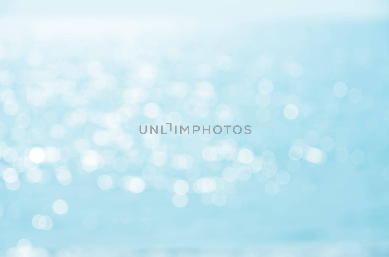 Blur blue sea water bokeh abstract background with sunshine