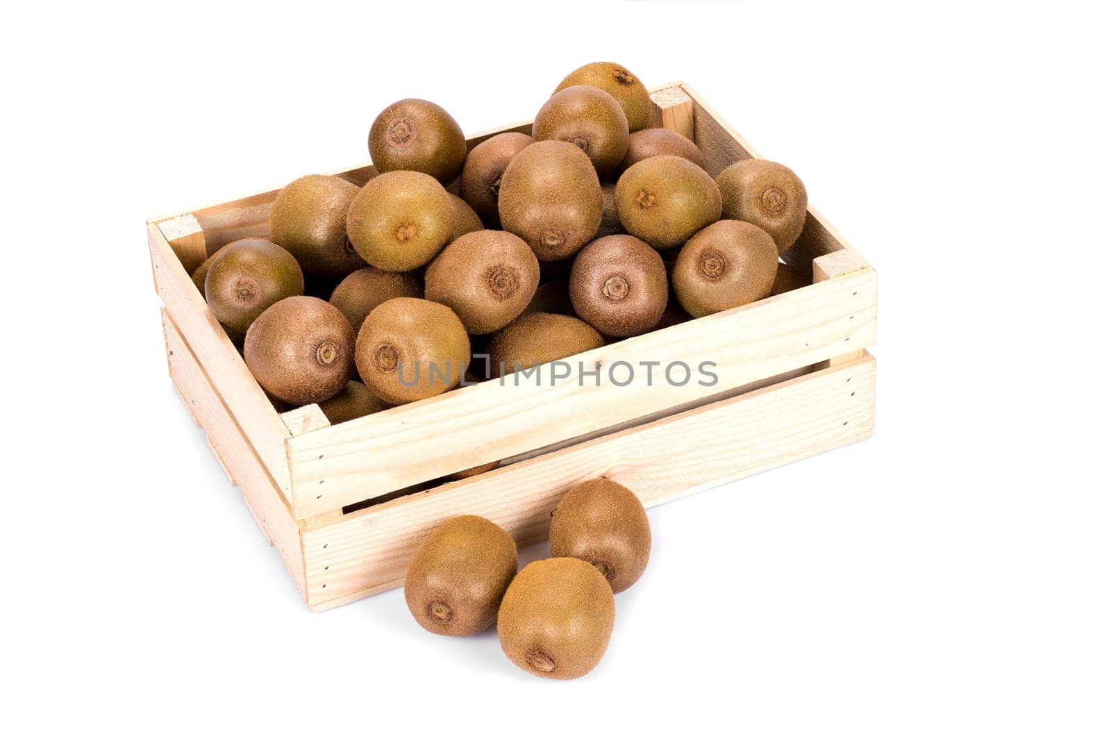 Wooden box filled with many ripe and fresh kiwi fruits and three whole fruits in front of it isolated on white background