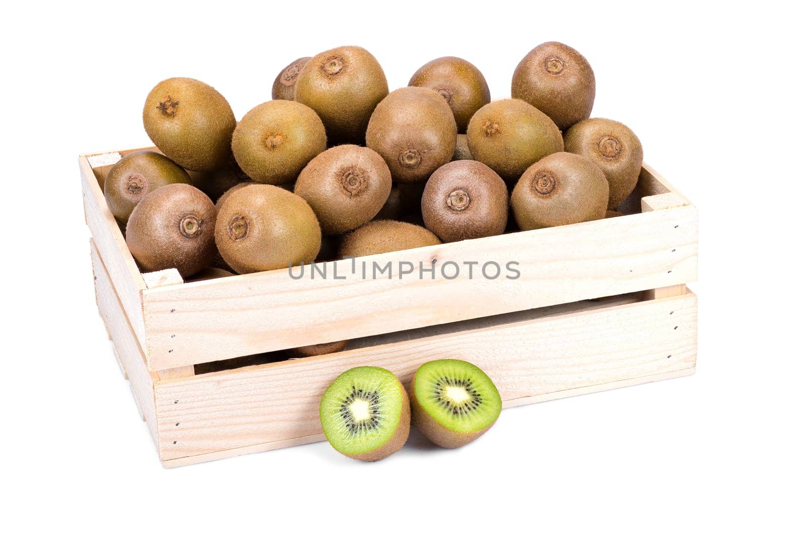 Wooden box filled with many ripe and fresh kiwi fruits and two half fruits isolated on white background