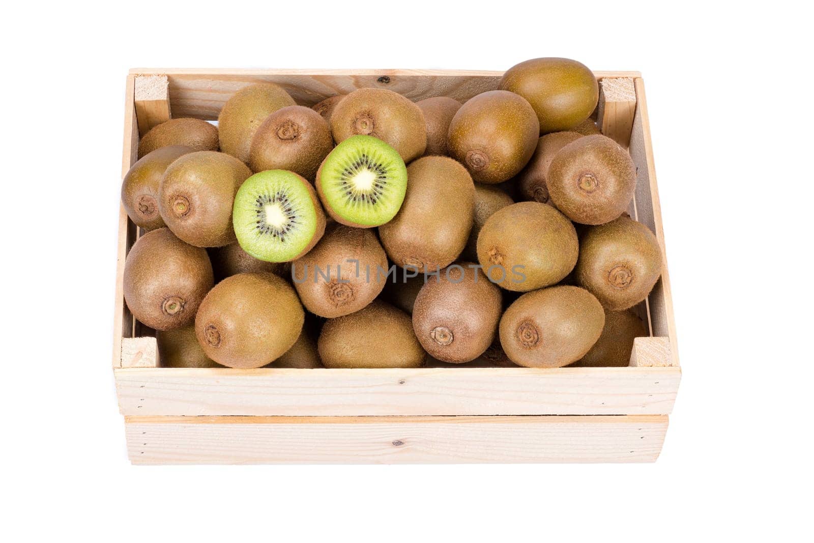 Wooden box filled with many ripe and fresh kiwi fruits and two half fruits isolated on white background