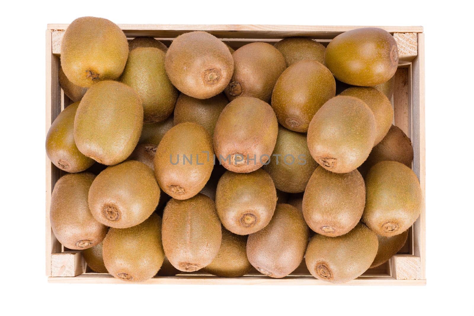 Wooden Box filled with many ripe Kiwi fruits isolated in white background view from top