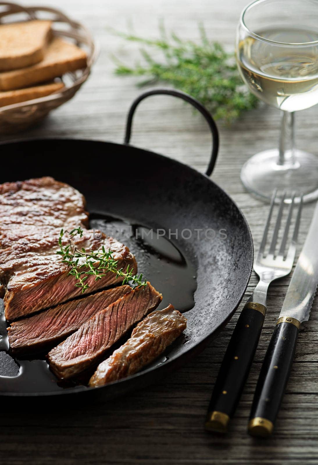 Grilled beef steaks with spices on wooden table