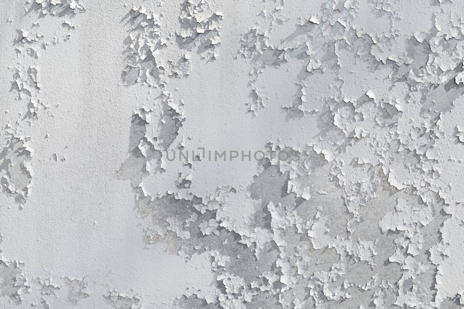 Peeling painted wall background. Old cracked grunge peeling paint texture.