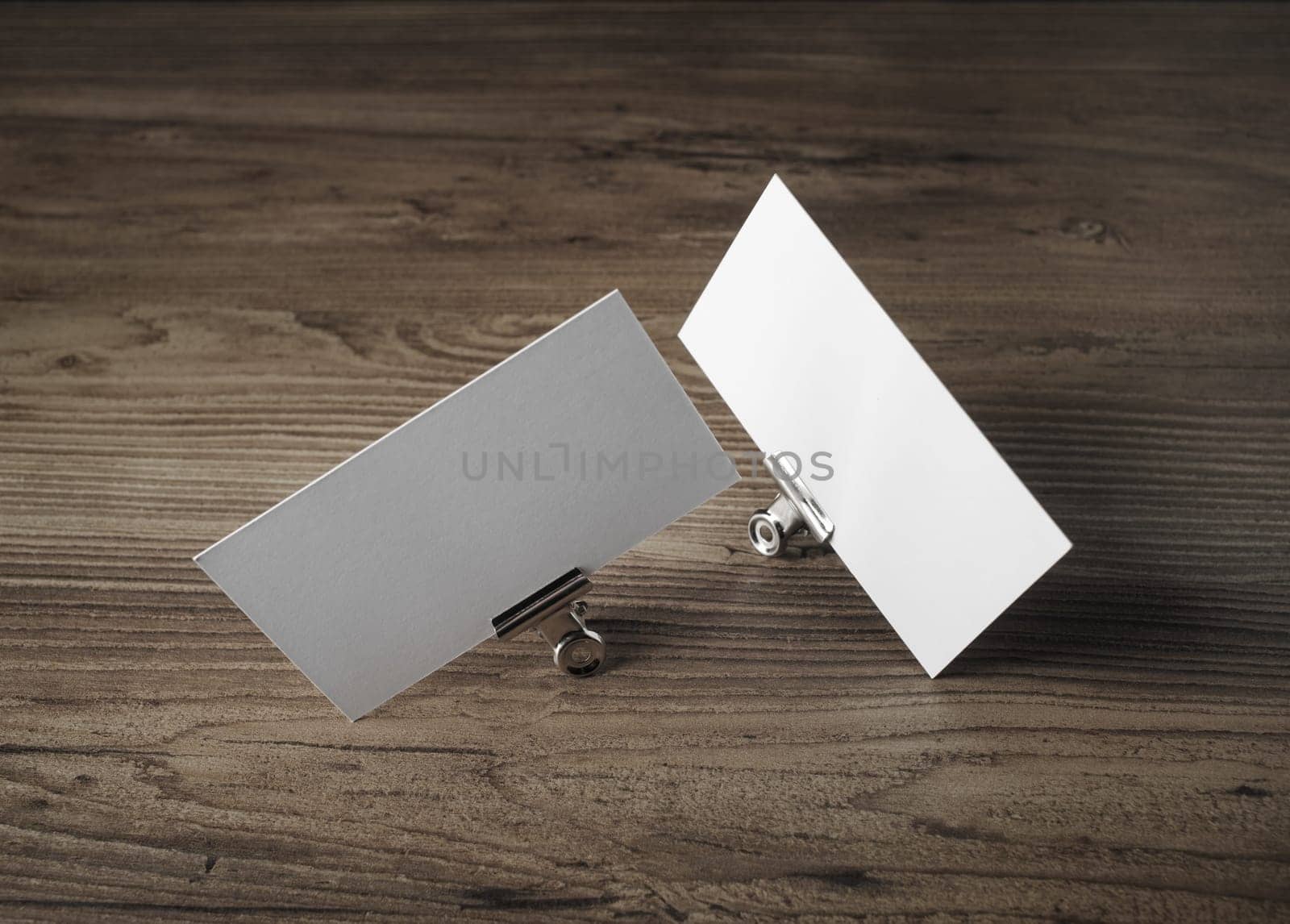 Blank business cards on wood background. For promotion of corporate identity.