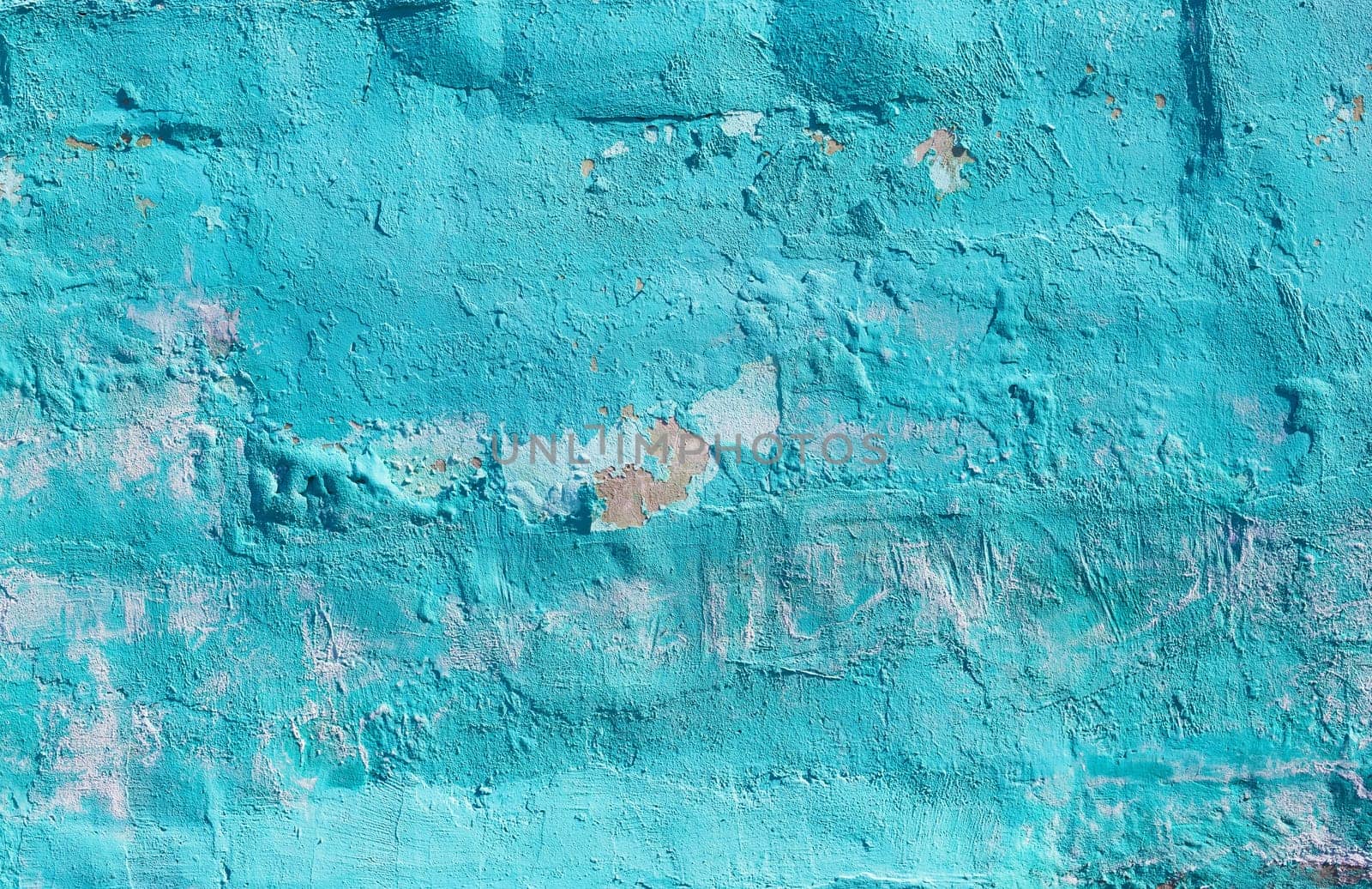 Wall with turquoise peeling paint texture. Old cracked industrial grunge background.