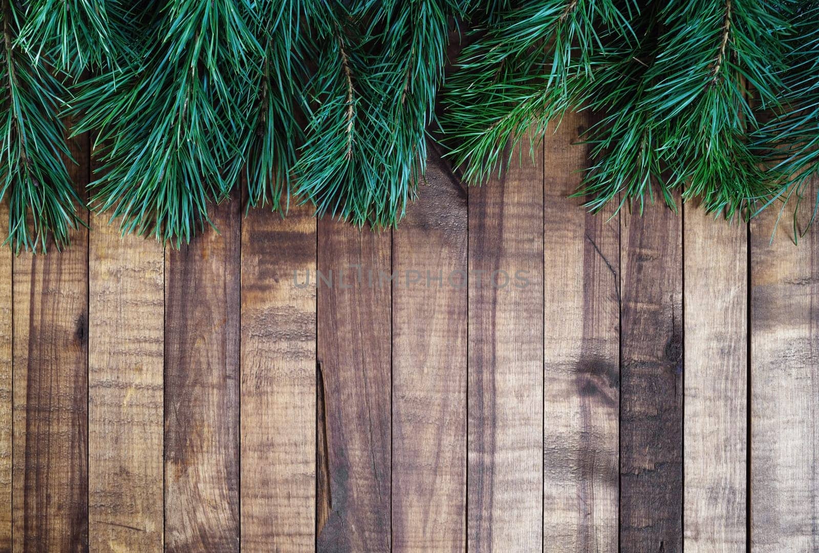 Vintage christmas wooden boards background with fir tree branches. Space for text. Flat lay.