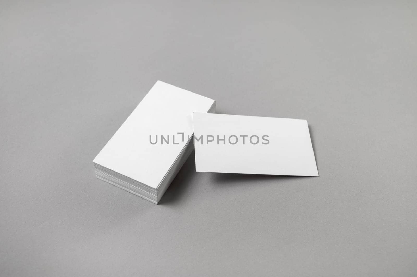 Blank business cards on gray paper background. Mockup for branding identity for designers.