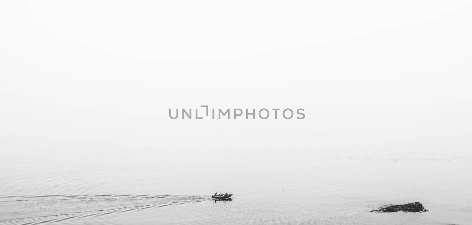 Marazion, England -  May 2018 : Small motor boat with people sailing in Cornish bay, Cornwall, England, UK