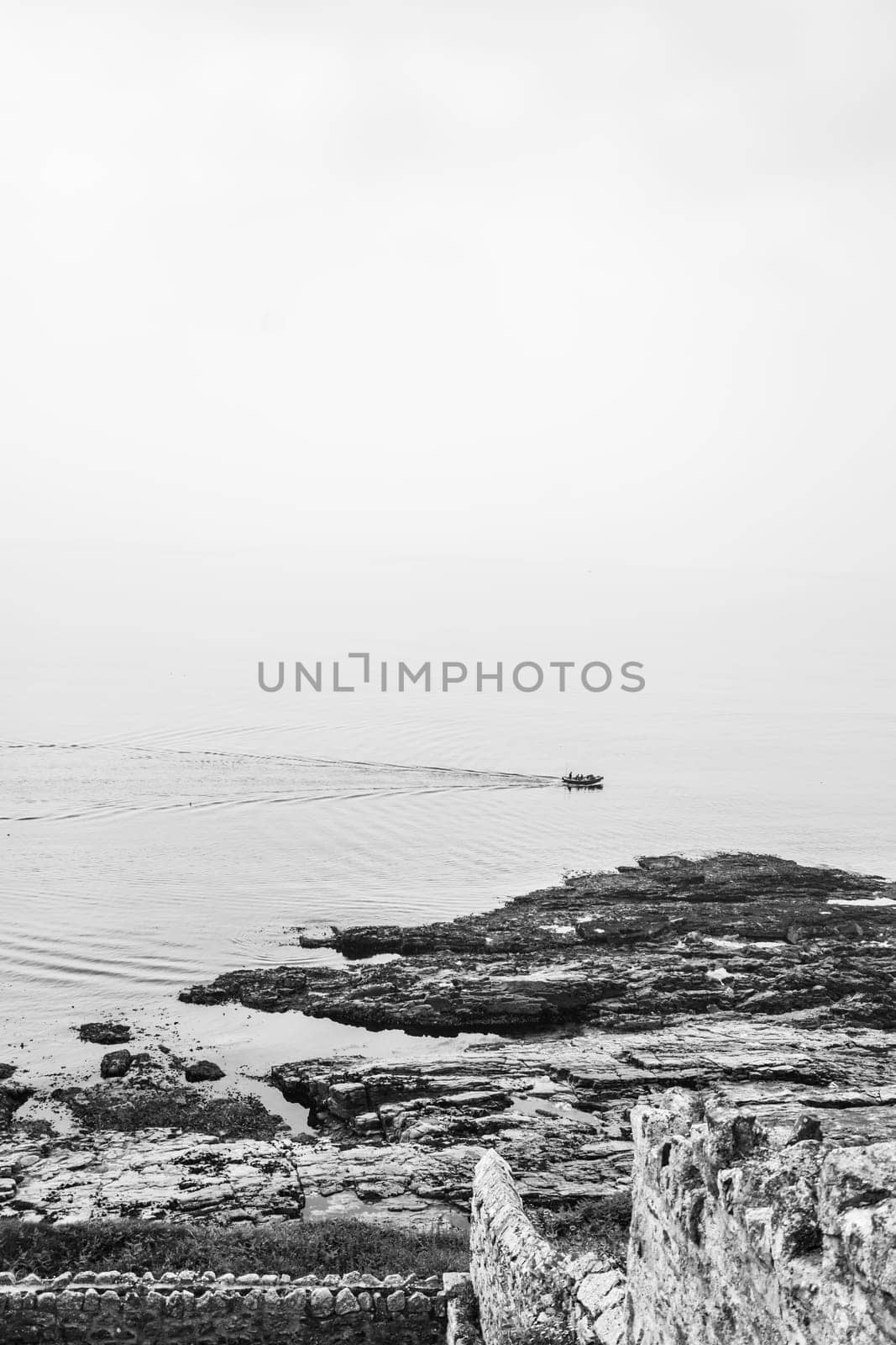 Marazion, England -  May 2018 : Small motor boat with people sailing in Cornish bay, Cornwall, England, UK