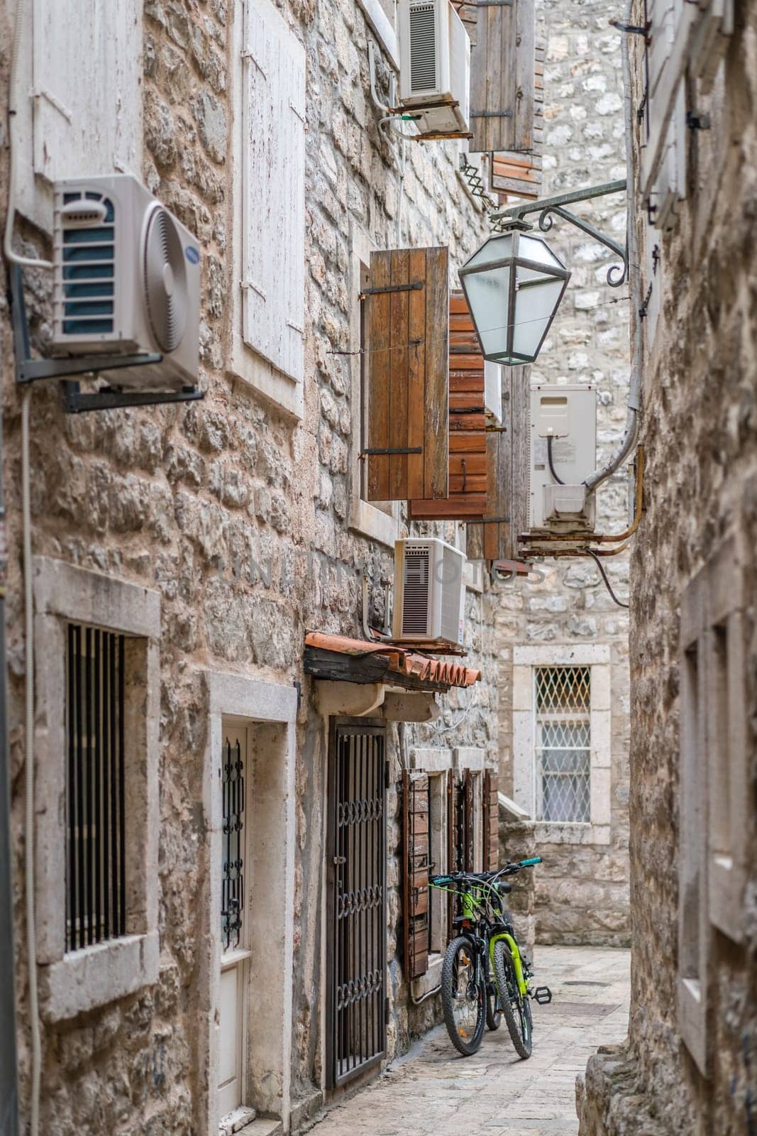 Budva, Montenegro - April 2018 : Two bicycles parked outside a property in the narrow street of Budva Old Town