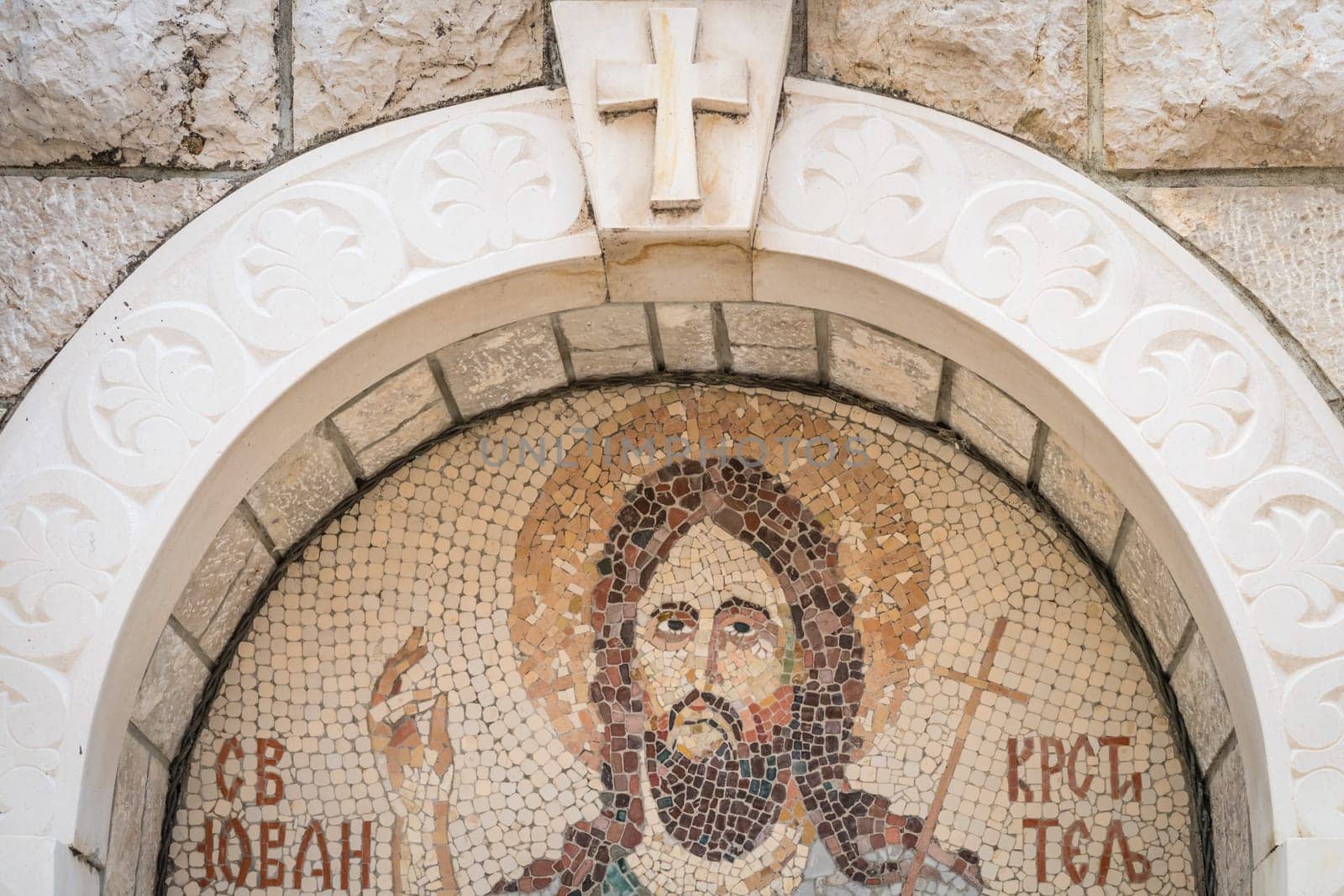 Cetinje, Montenegro - April 2018 : Religious mosaic depicting Jesus Christ above home entrance to house