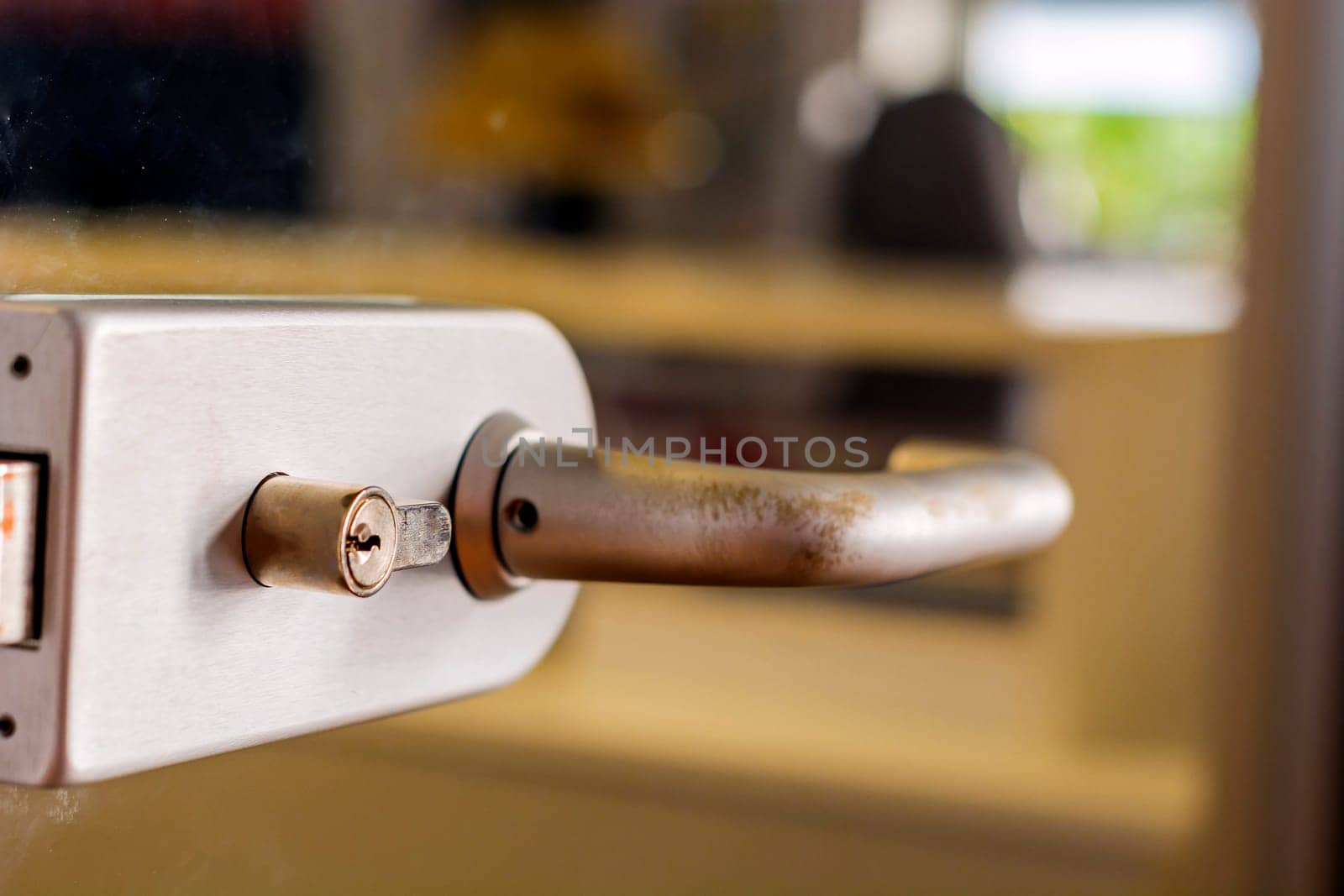 An abstract detail of a contemporary door handle for a glass door