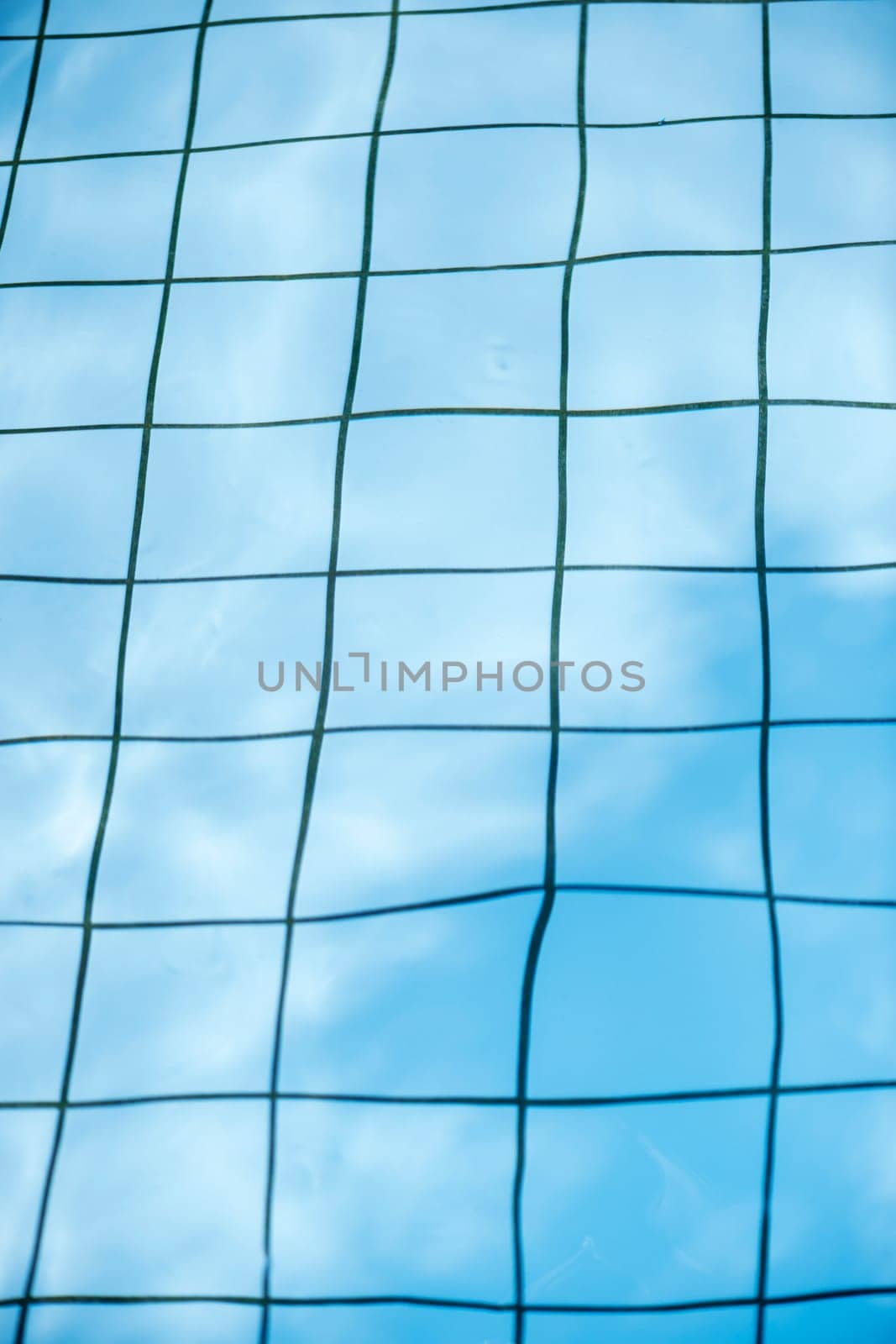 View of the bottom of a tiled swimming pool with distorted joints.