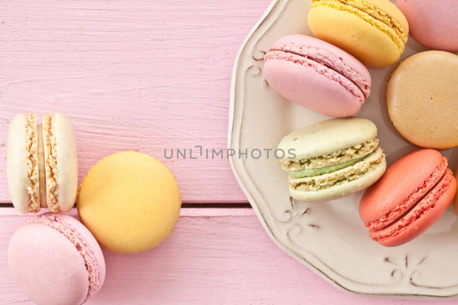 Colorful French macarons on vintage plates