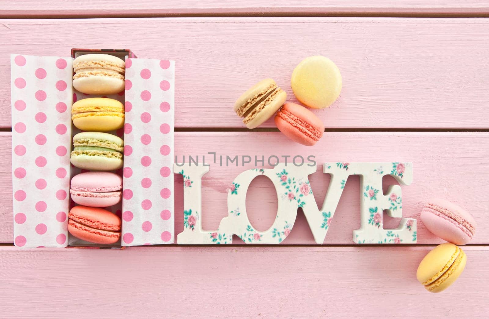 Colorful French macarons in box with dots