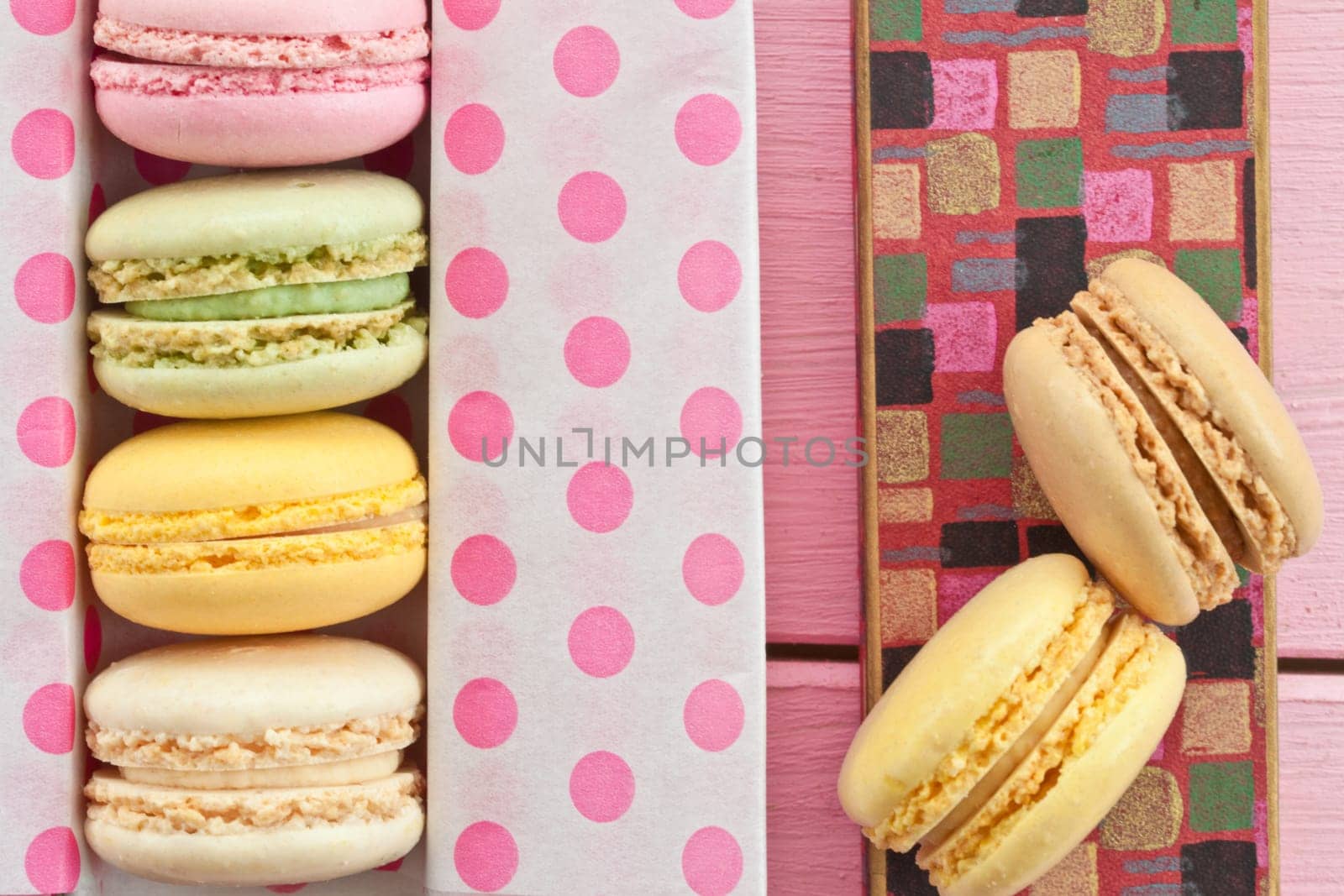 Colorful French macarons in box with dots