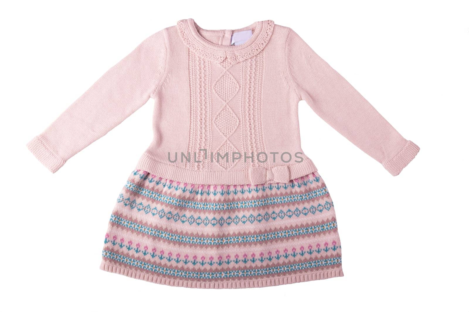 Clothes for children. A beautiful pink bright girl dress with colorful pattern isolated on a white background. Children fashion.