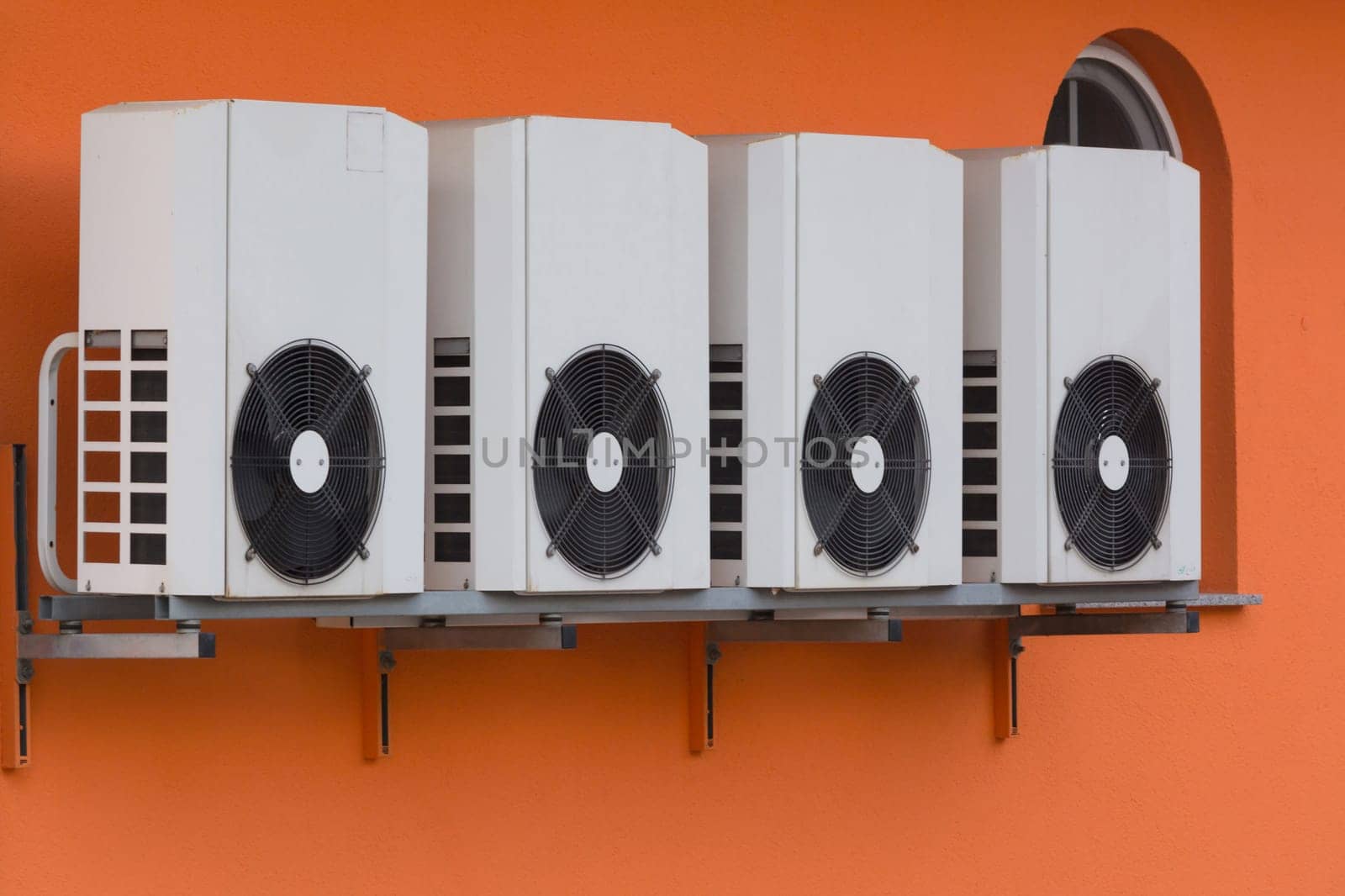 Air conditioning compressors newly installed on a house wall