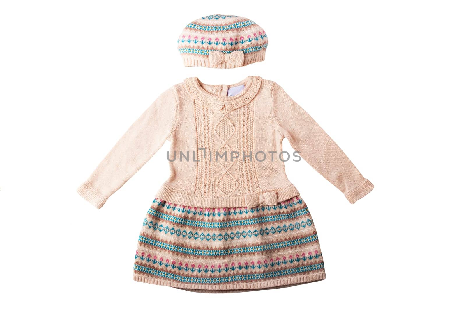 Clothes for children. A beautiful pink bright girl dress and hat with colorful pattern isolated on a white background. Children fashion.