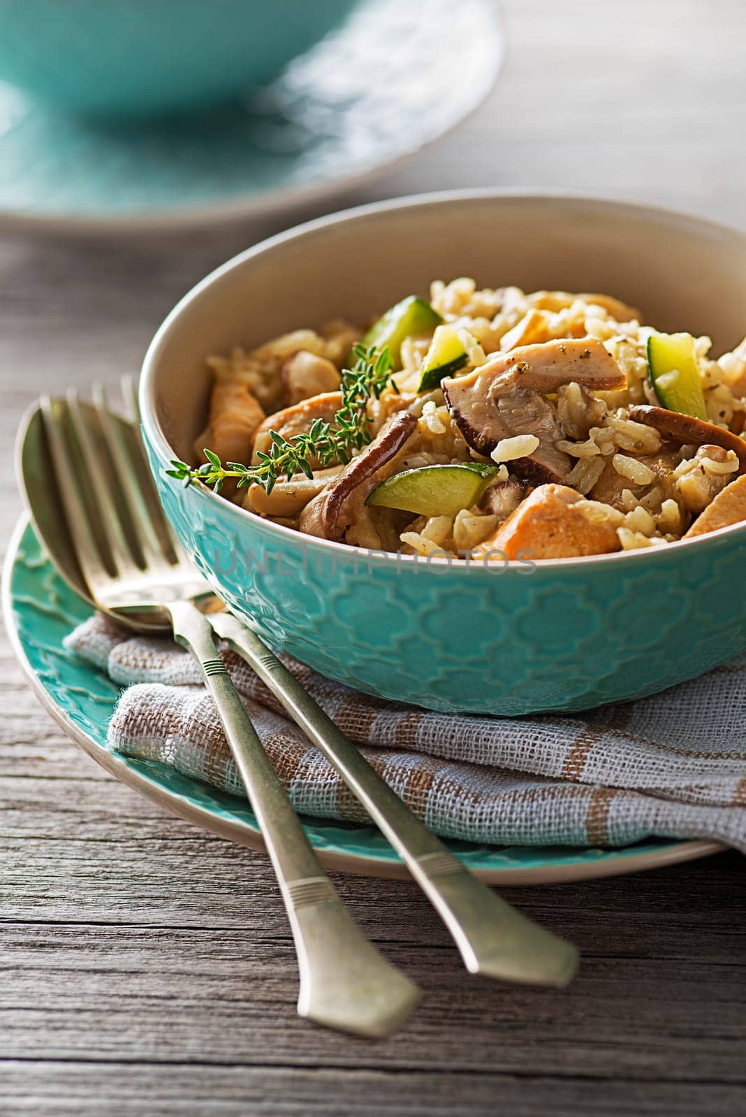 Risotto with porcini mushroom and meat on wooden table
