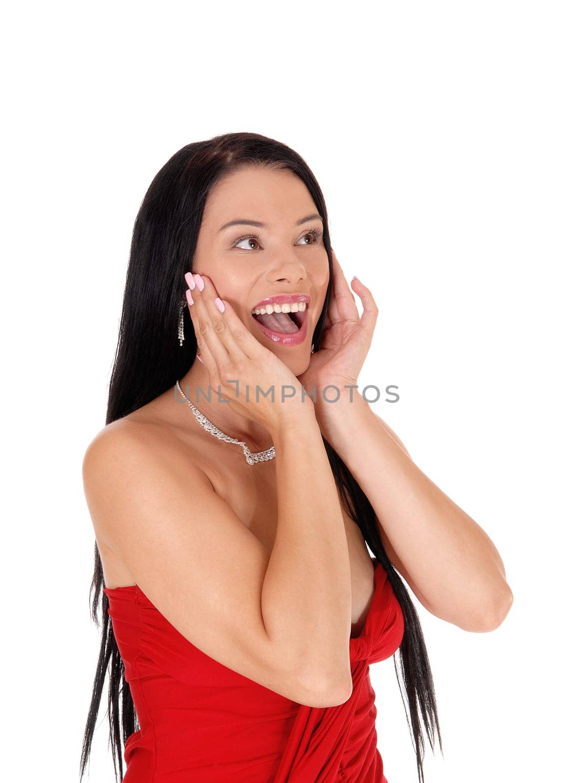 A gorgeous young woman standing with her hands on face, laughing.and her mouth open, isolated for white background.