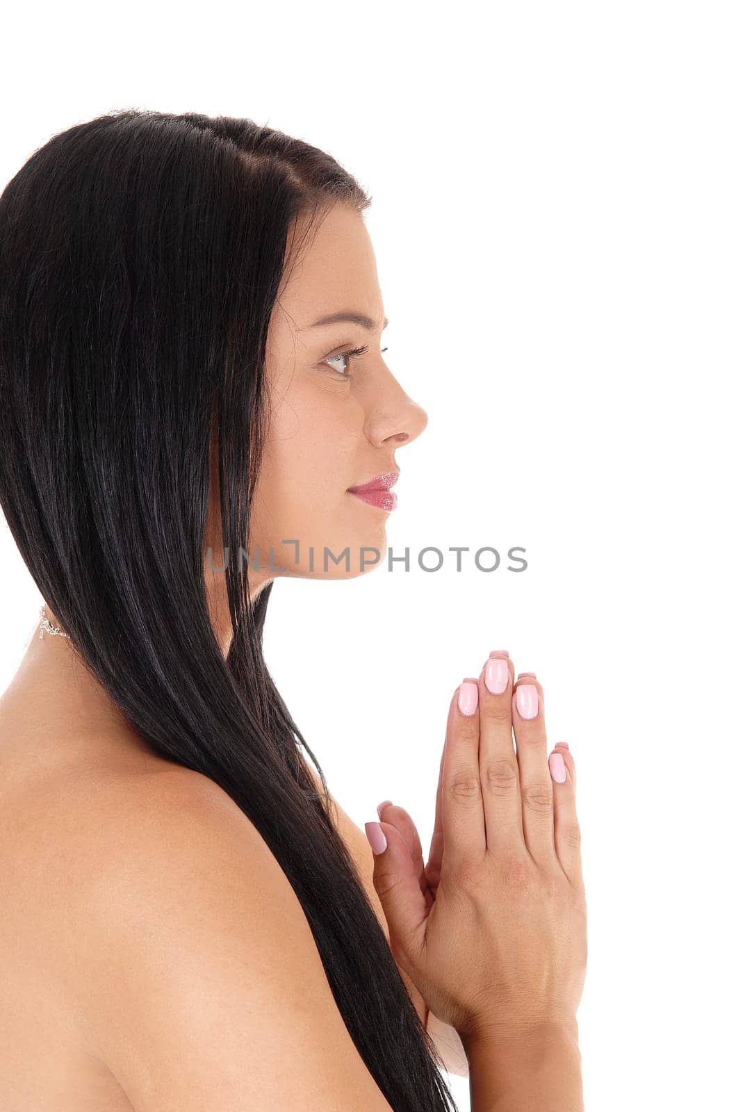 A close up image of a beautiful woman praying with her hands folded.and long black hair, open eyes, isolated for white background.