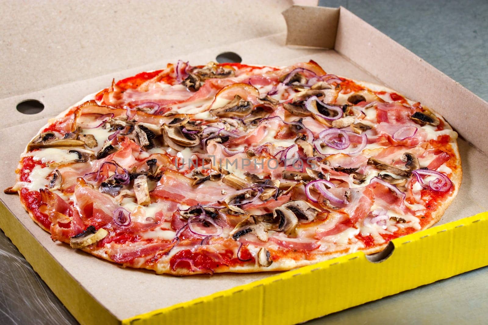 Pizza prosciutto crudo prepared and put in cardboard packaging