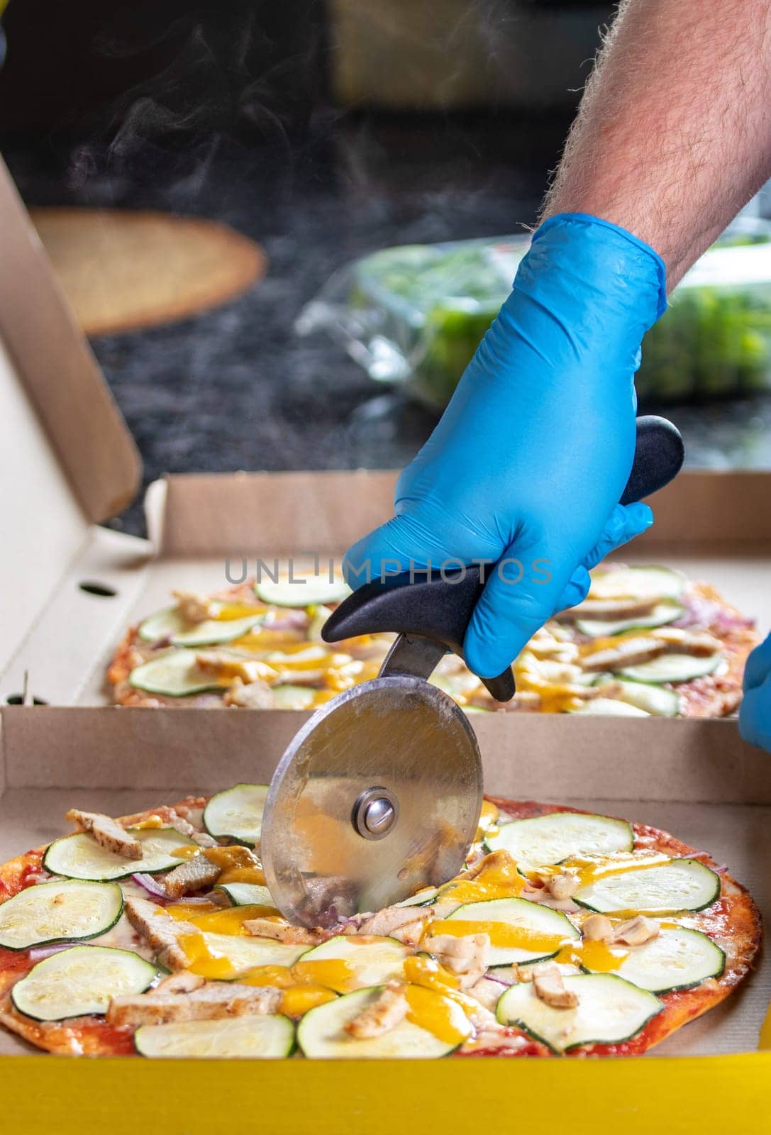 Vegetarian pizza sliced with rotary in the packing box by the chef