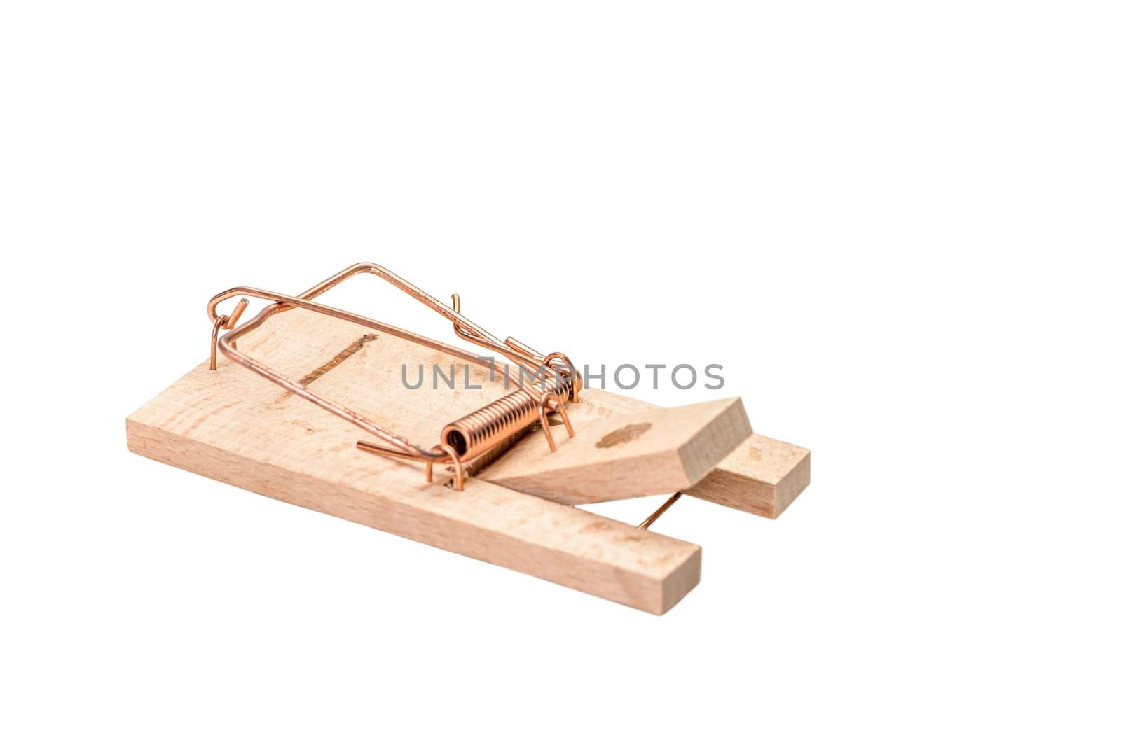 Small cocked wooden mousetrap isolated on white.