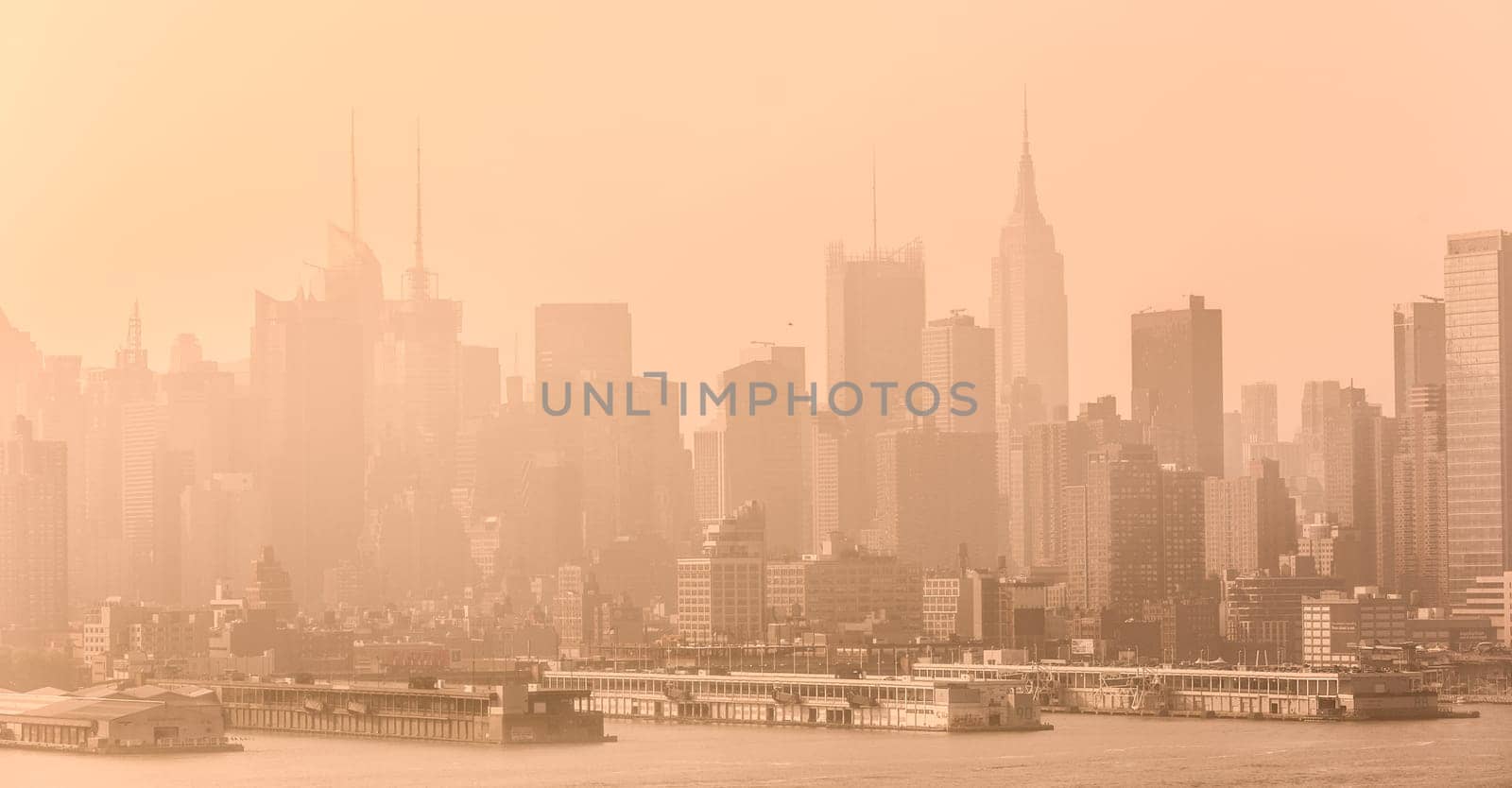 New York City midtown Manhattan skyline panorama view from Boulevard East Old Glory Park over Hudson River on a misty morning.
