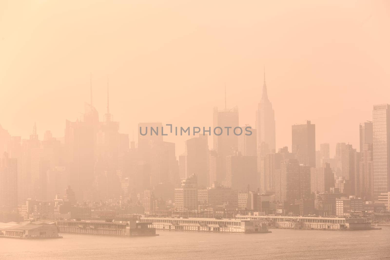 New York City midtown Manhattan skyline panorama view from Boulevard East Old Glory Park over Hudson River on a misty morning.