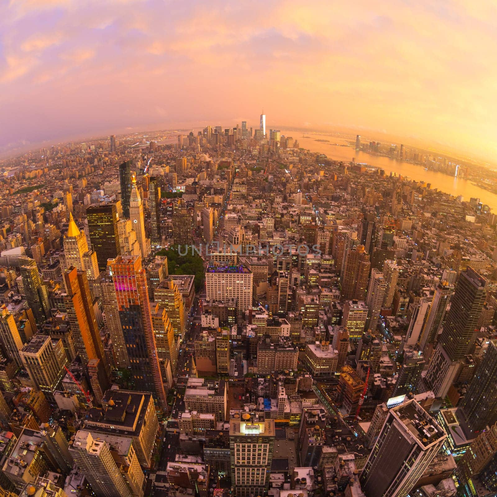 New York City skyline with Manhattan skyscrapers at dramatic vibrant after the storm sunset, USA. Rainbow and lightnings can be seen in background over Brooklyn bridge.