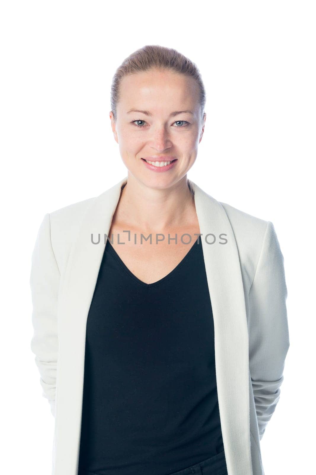 Portrait of casualy dressed,cheerful, beautiful, smart, young businesswoman in standing against white background.