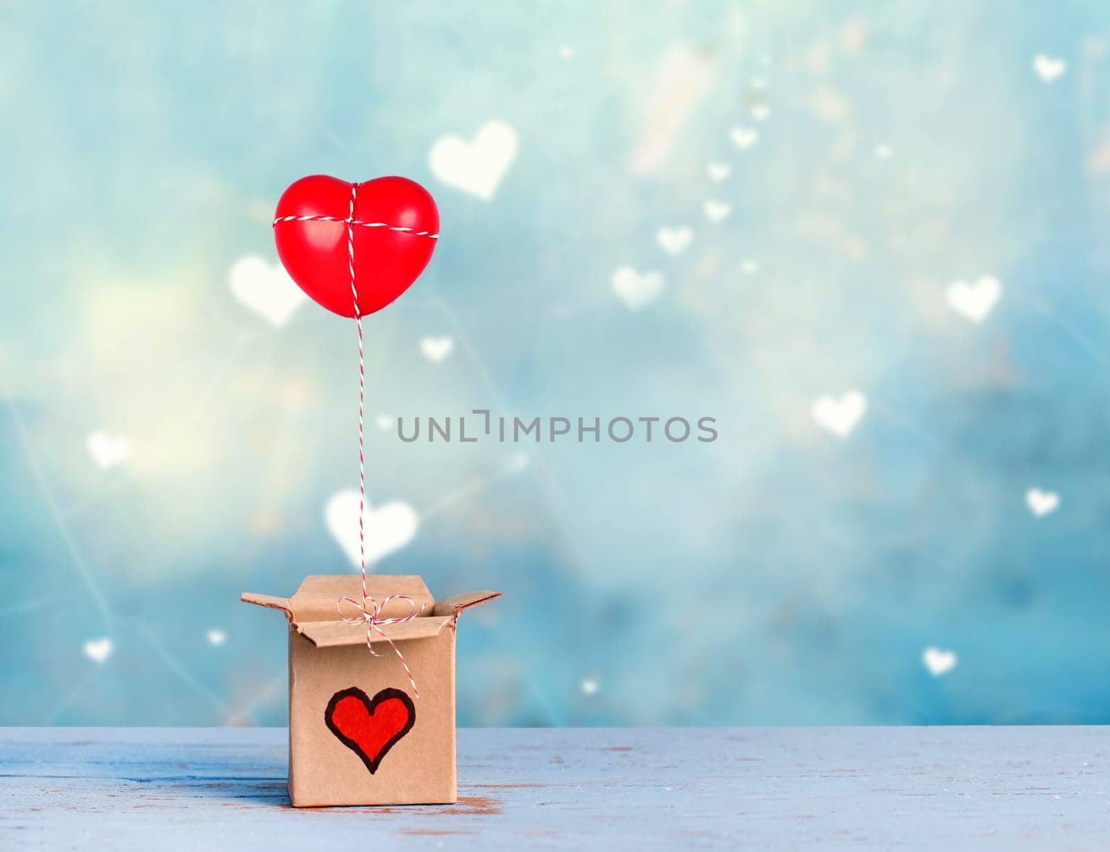 lovely gift box with red heart on blue romantic background